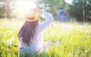 a woman holding her hat